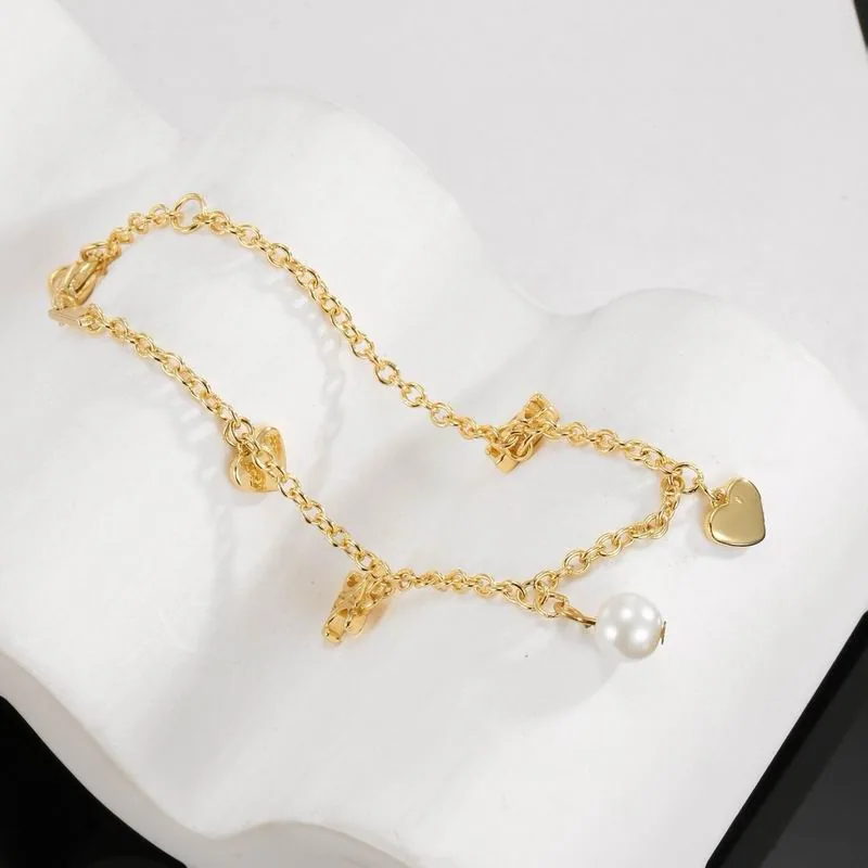 Celine gold-tone bracelet with multiple charms, catalog view 1, 07yxs06