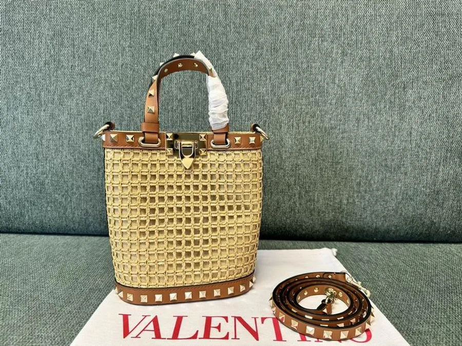 Valentino 2044 Natural Woven Bucket Bag compact natural woven bucket bag with top handle, trim, and strap shown view 1