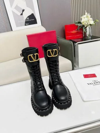 Valentino MNH0801 Black V-Detail Tall Boots black tall lace-up boots with lug sole and gold-tone V-detail on the shaft view 1