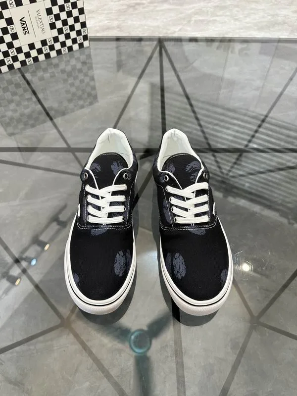 Valentino MNS0701 Black White Low-Top Sneakers black low-top sneakers with white laces, white side stripe, and white sole edge view 1