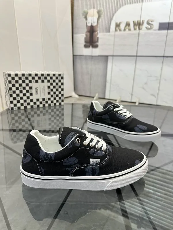 Valentino MNS0701 Black White Low-Top Sneakers black low-top sneakers with white laces, white side stripe, and white sole edge view 3