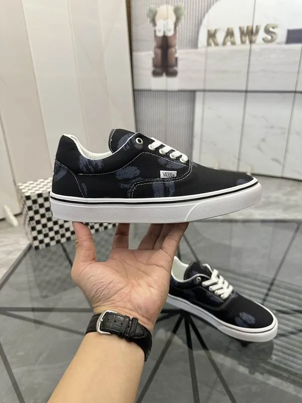 Valentino MNS0701 Black White Low-Top Sneakers black low-top sneakers with white laces, white side stripe, and white sole edge view 4