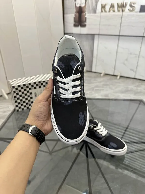 Valentino MNS0701 Black White Low-Top Sneakers black low-top sneakers with white laces, white side stripe, and white sole edge view 5