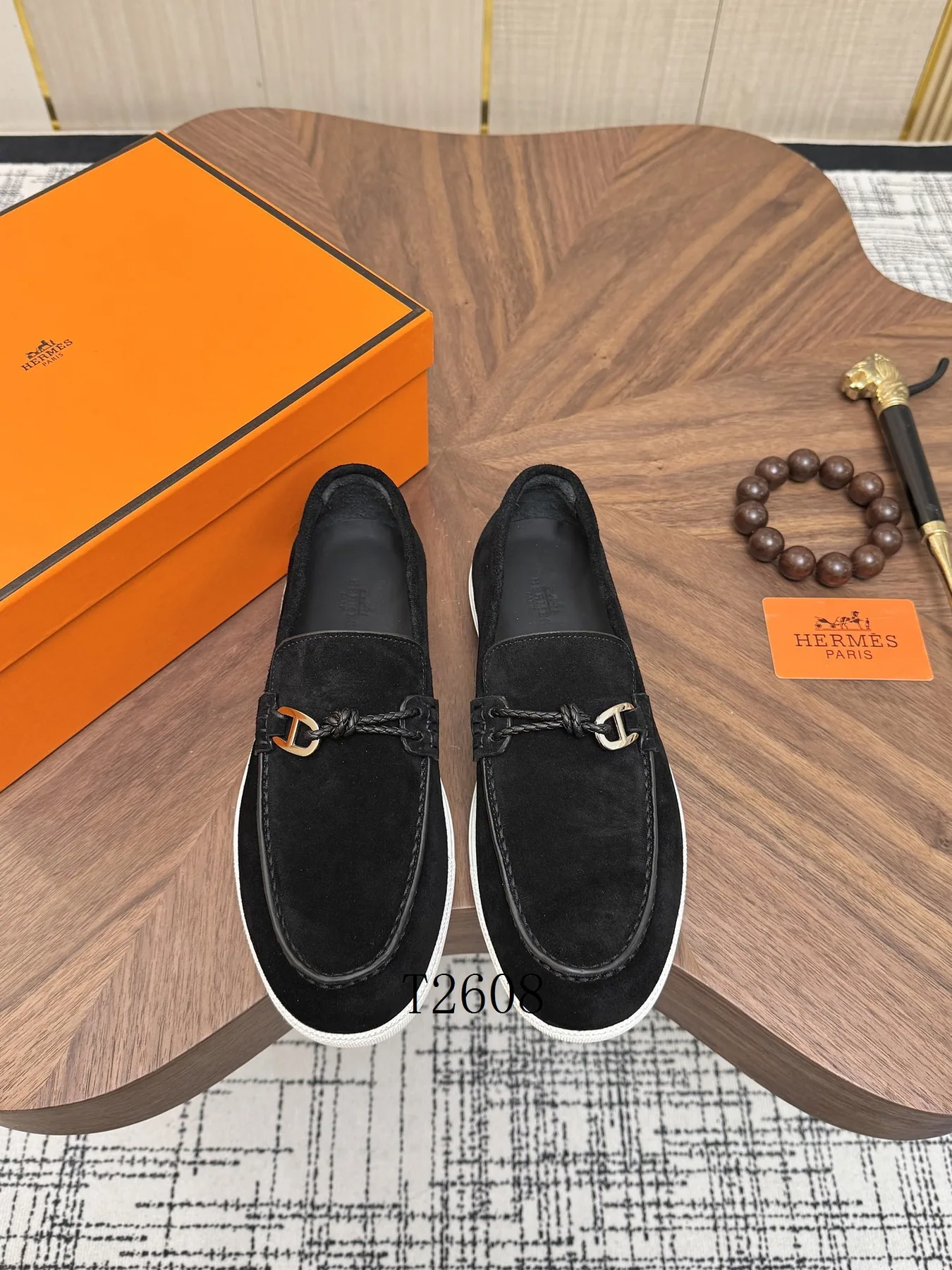 Black slip-on sneakers shown from the front for the sizing guide